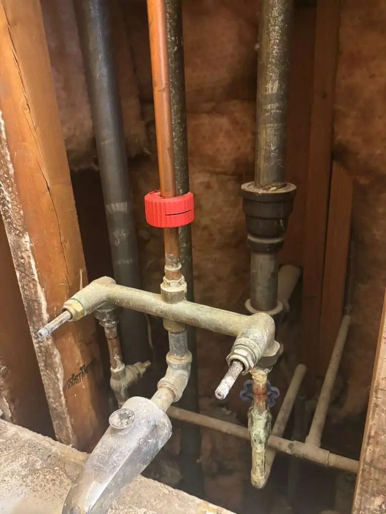 Old bathtub plumbing before repair